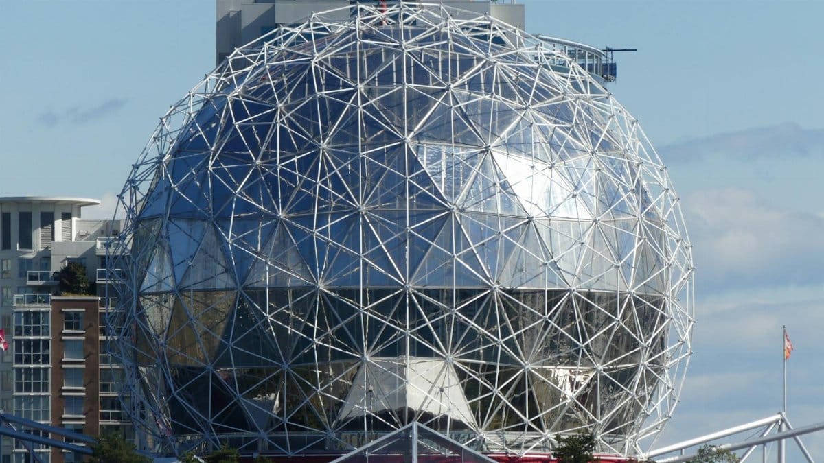 Capture of geodesic dome against Vancouver cityscape with clear skies.