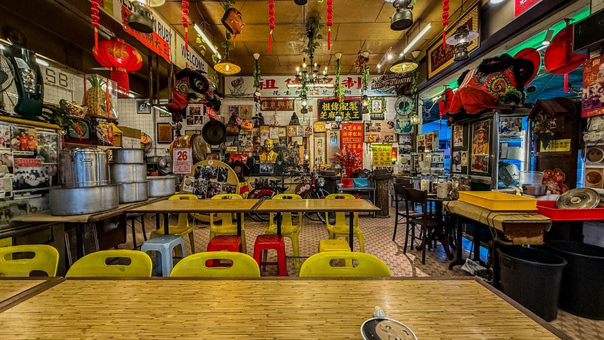 A vibrant interior of a Malaysian eatery adorned with cultural decorations and vivid colors in Kuala Lumpur.