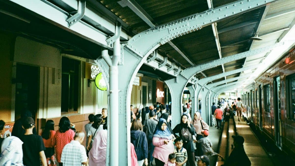 A bustling scene of commuters at a vibrant urban train station showcasing public transportation life.