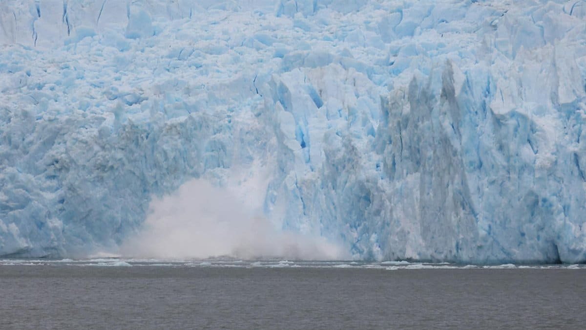 Spectacular view of a glacier calving into the ocean in Chilean Patagonia, capturing nature's raw power.