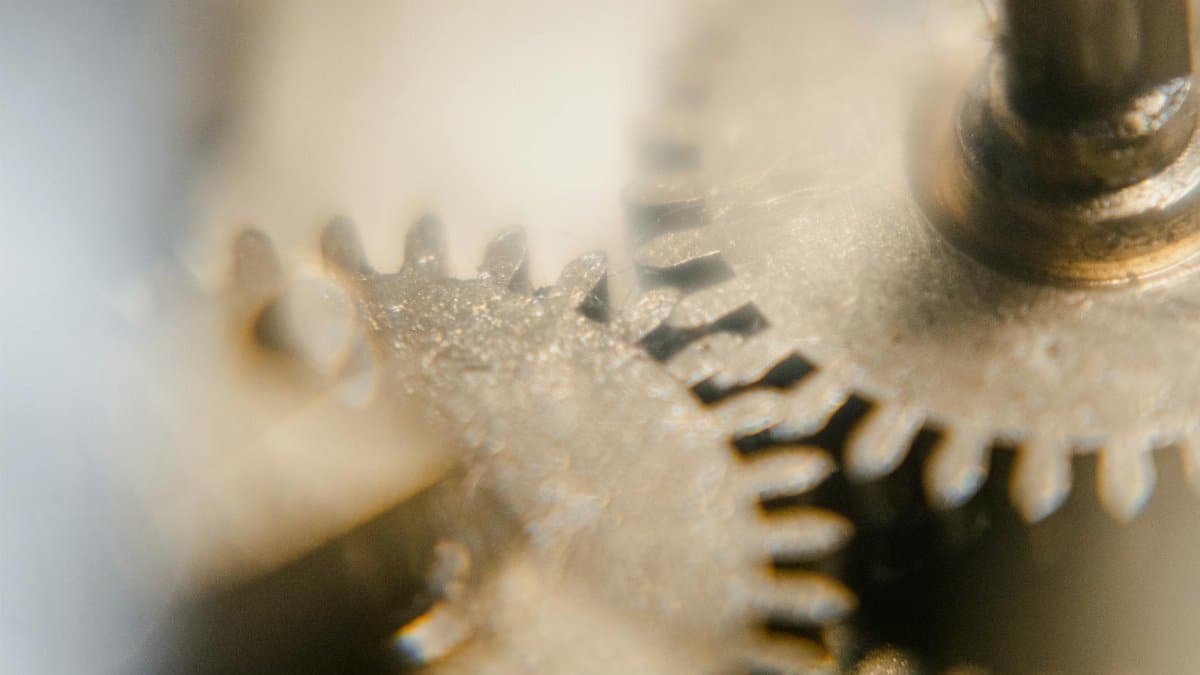 Detailed view of clock gears and cogs in a vintage mechanism showcasing precision engineering.