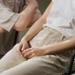 A couple relaxing indoors, highlighting intimacy and connection with a focus on a modern sex toy.