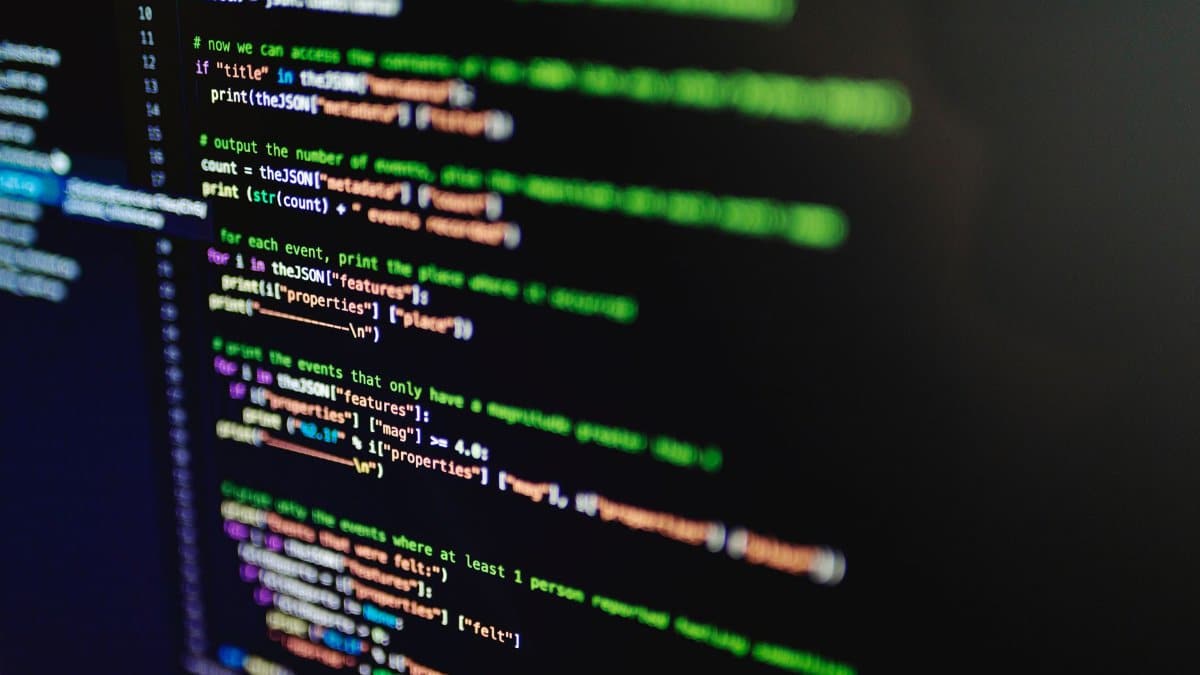 High-resolution image of colorful programming code highlighted on a computer screen.