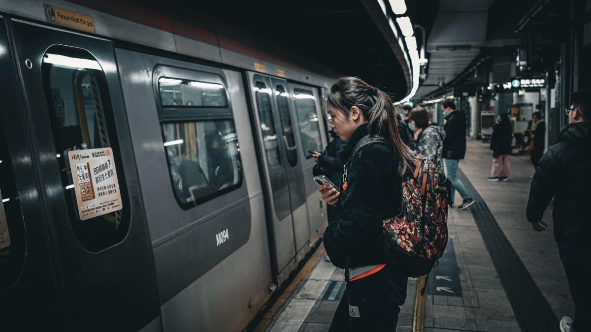 Commuters boarding a subway train at an underground station, showcasing public transit dynamics.