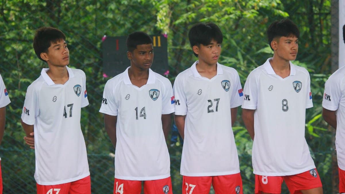 Four soccer players in uniform standing outdoors, ready for a match in Myawaddy, Myanmar.