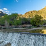 Serene view of Sabino Canyon dam waterfall and mountains in Tucson, Arizona.