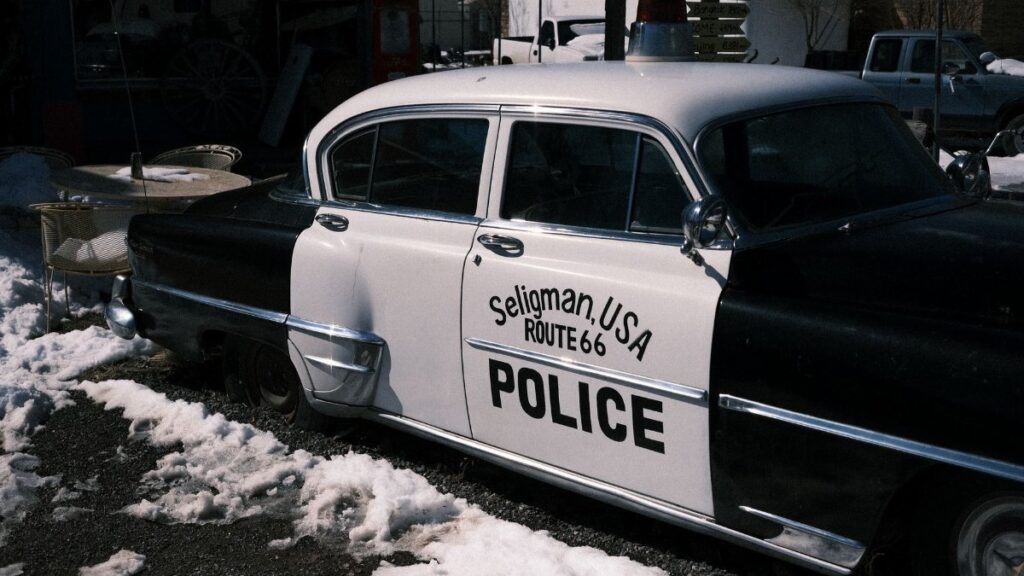 Retro police car in Seligman, Arizona, on snow-covered Route 66.