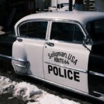 Retro police car in Seligman, Arizona, on snow-covered Route 66.