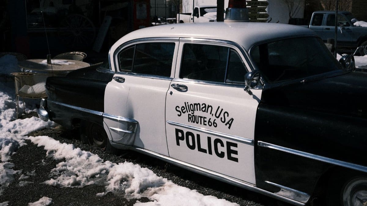 Retro police car in Seligman, Arizona, on snow-covered Route 66.