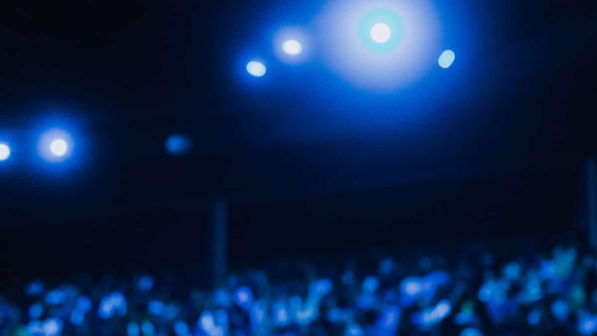 Abstract image of blurred auditorium lights and audience.