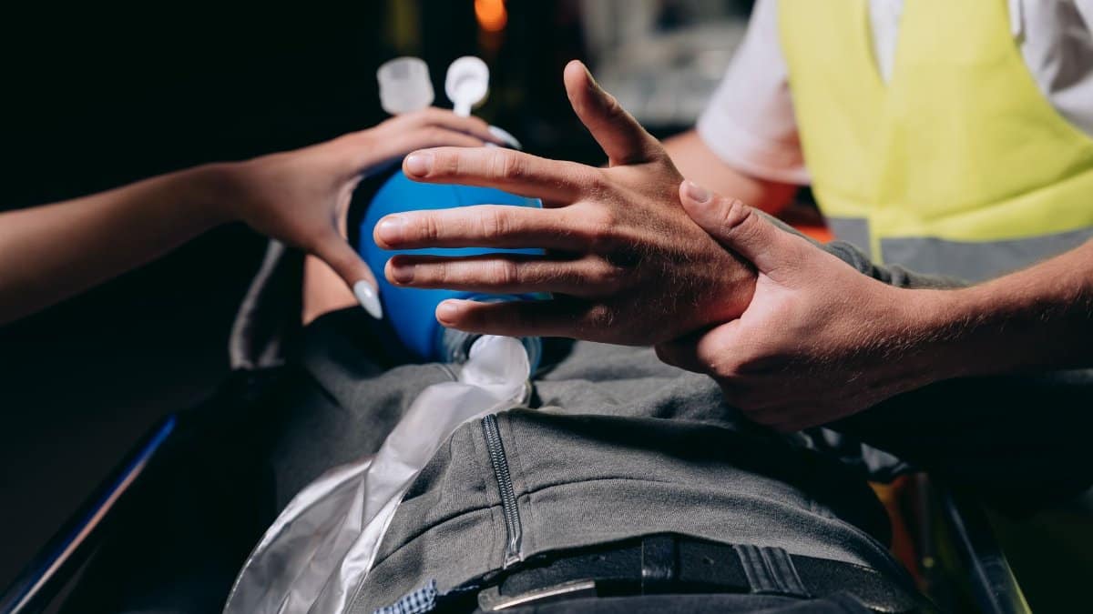 Close-up of an emergency responder using an ambu bag on a patient in a critical healthcare situation.