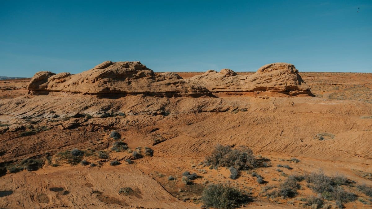 Scenic view of red rock formations under a clear blue sky in Page, Arizona.
