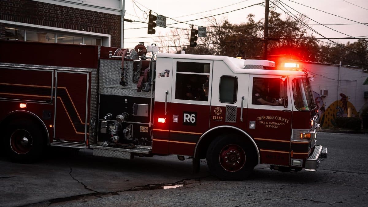 Fire truck from Cherokee County Fire & Emergency Services on city street at twilight.