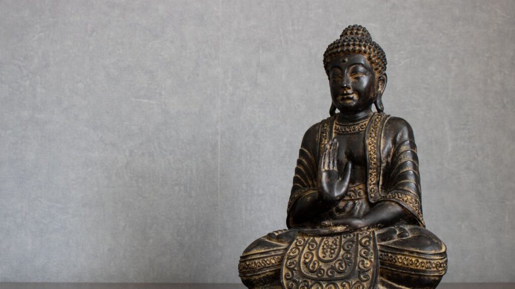 Elegant bronze Buddha statue representing peace and spirituality in meditation setting.
