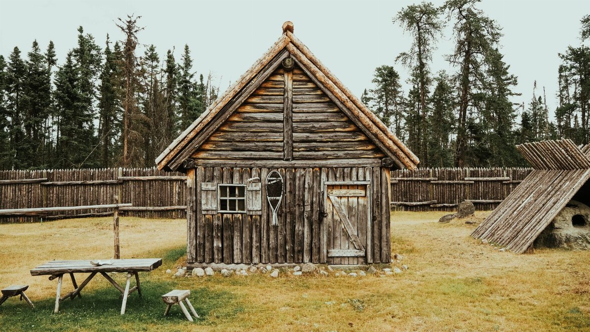 Charming rustic log cabin in Saint-Félicien, Quebec, displaying classic wooden architecture amidst a rural landscape.