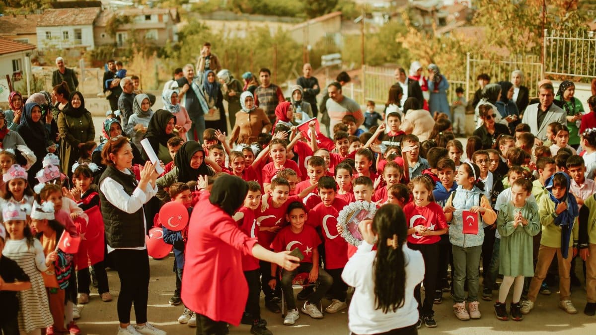 A joyful outdoor celebration with children and adults during daylight.