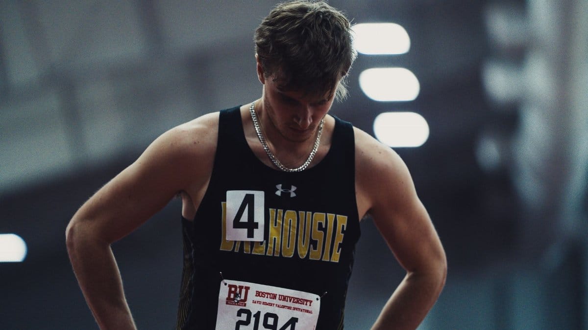 Athlete in sportswear focusing before competition at Boston University track event.