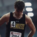 Athlete in sportswear focusing before competition at Boston University track event.