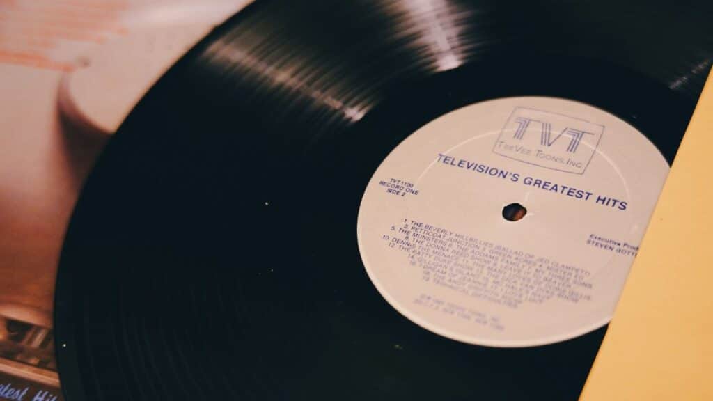 A vintage vinyl record titled 'Television's Greatest Hits' on a turntable.
