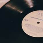 A vintage vinyl record titled 'Television's Greatest Hits' on a turntable.