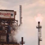 A factory in Ciudad Guayana emitting smoke and fire, showcasing industrial pollution.