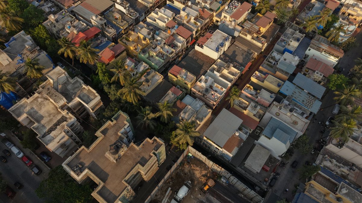 Aerial photograph showcasing the dense urban housing and vibrant cityscape of Mumbai, India.