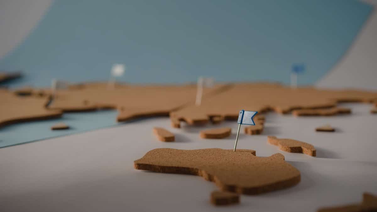 Cork world map with colorful pins marking destinations for travel planning and geography learning.