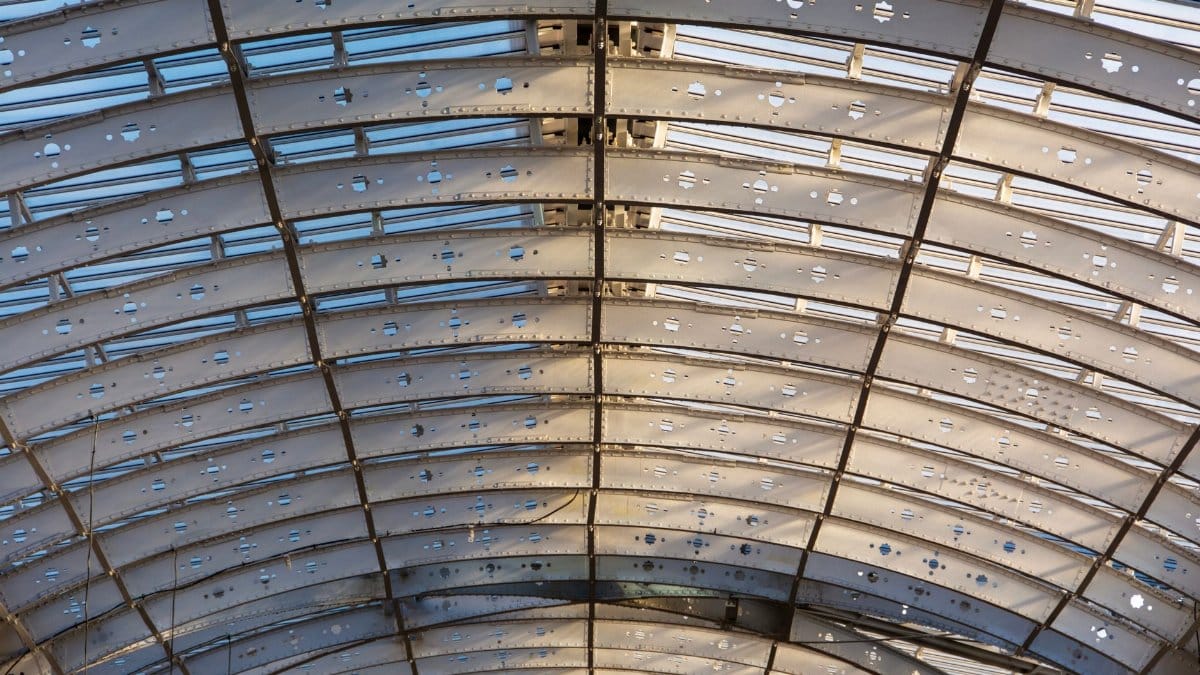 Architectural details of a steel arch ceiling at a railway station in London.
