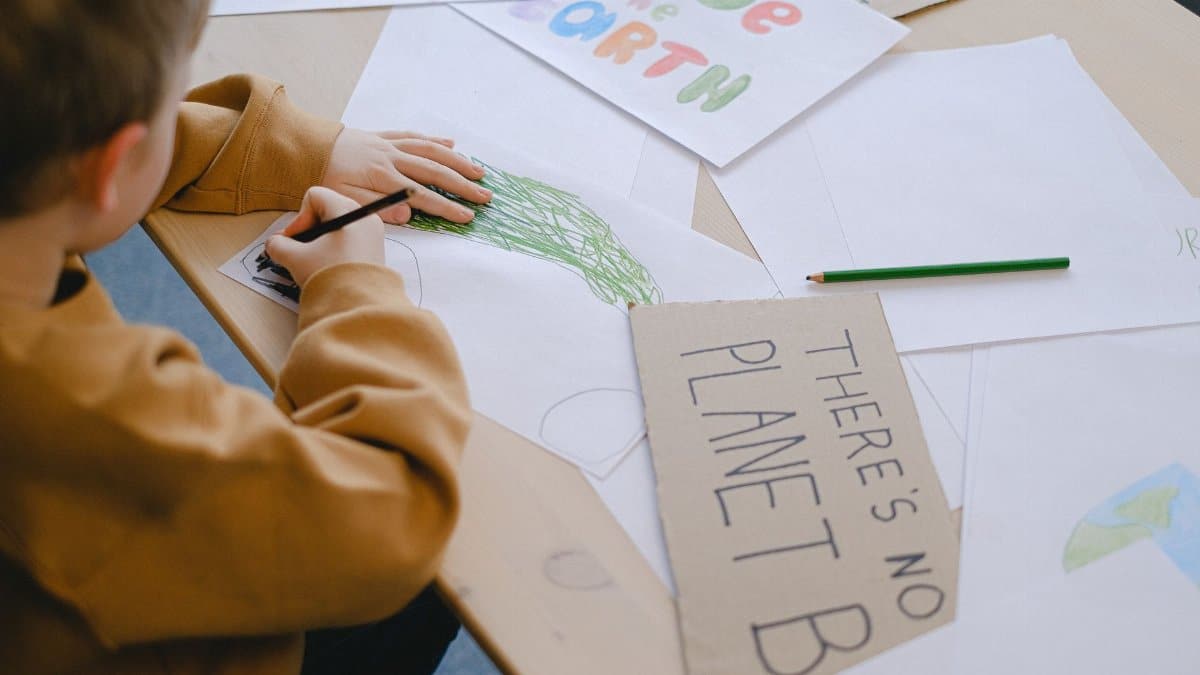 A child creates eco-friendly posters promoting environmental awareness.