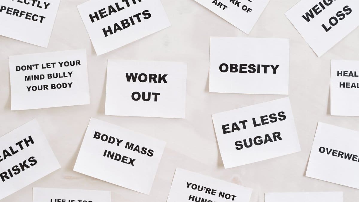 Collection of motivational quotes promoting health and wellness on paper cards.