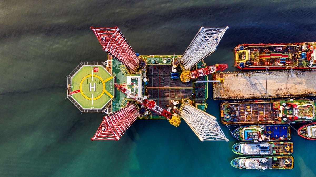 Drone shot of an offshore oil platform with helipad in Jakarta harbor.