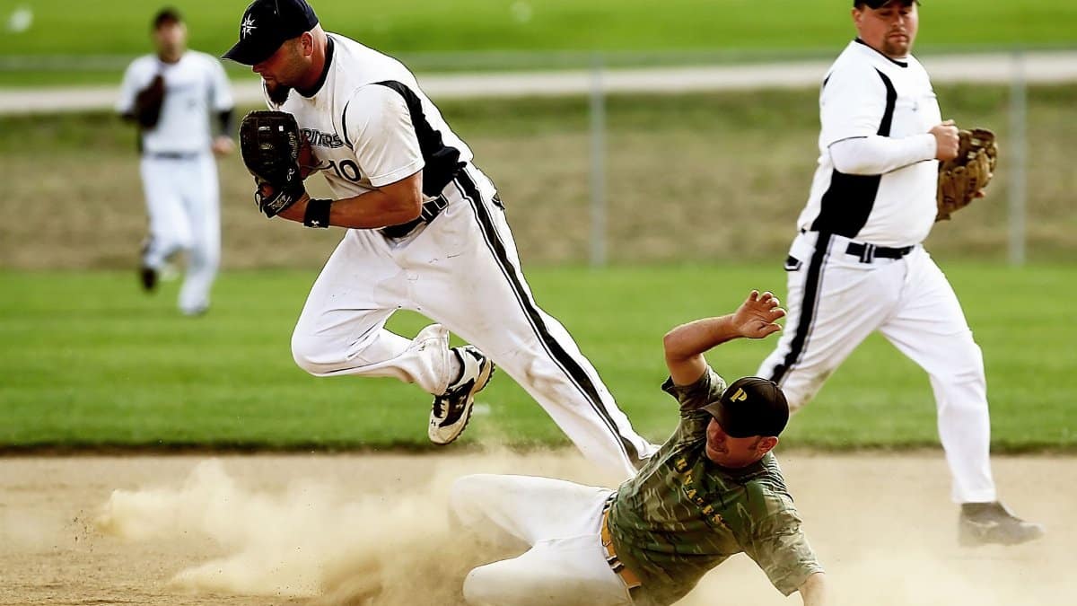 Dynamic baseball scene capturing players in action with a dramatic slide on the field.