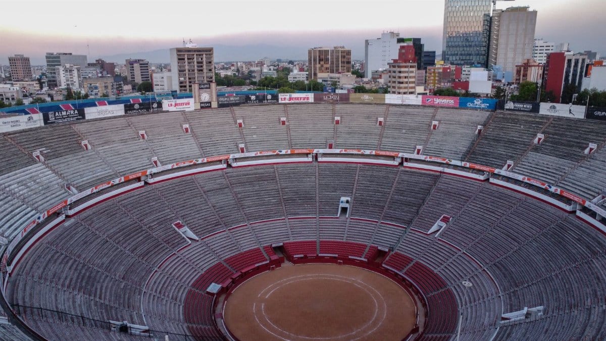 Stunning aerial view of the Plaza de Toros arena in Mexico City under a clear sky.