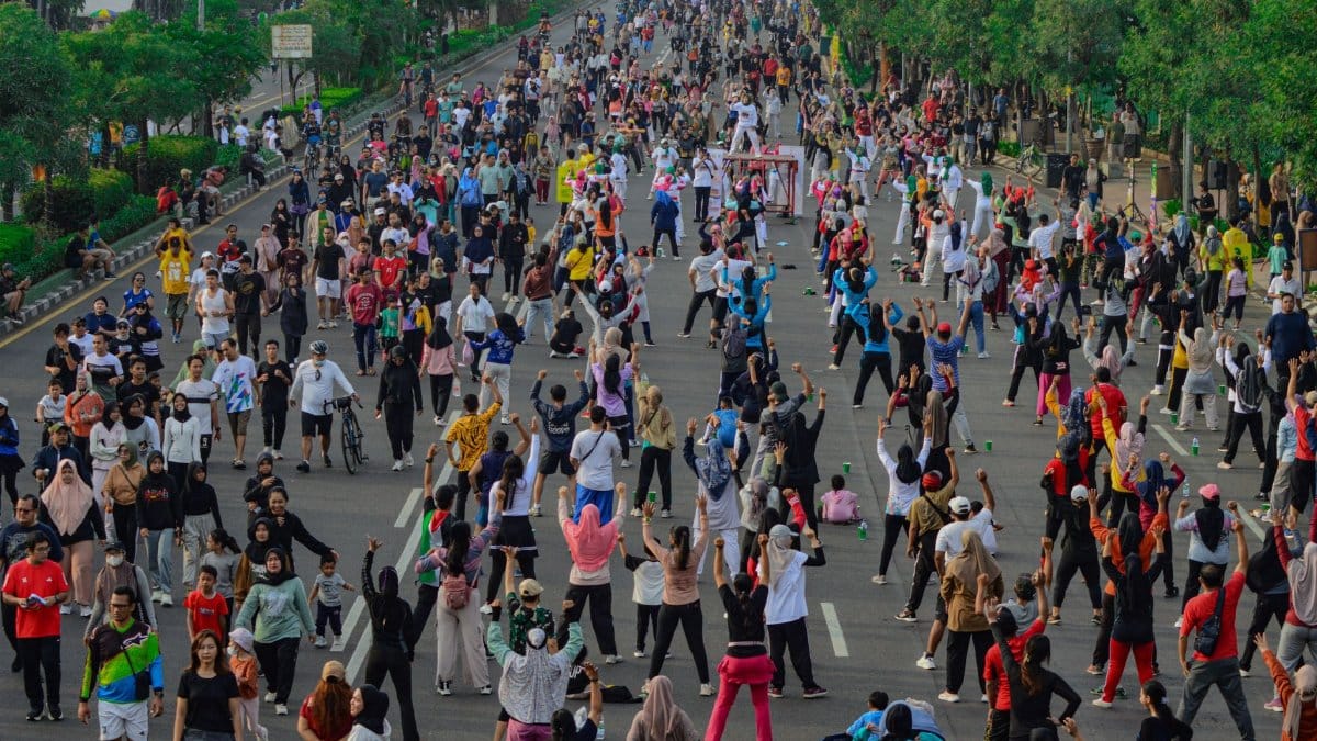 People participating in a large outdoor fitness event on a city street.