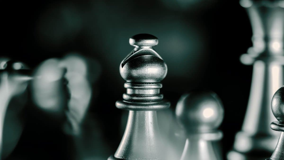 Artistic black and white close-up of chess pieces with selective focus, emphasizing strategic gameplay.