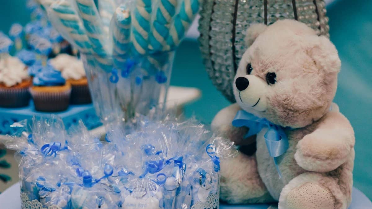 Charming setup for a baby shower with blue decorations and treats.