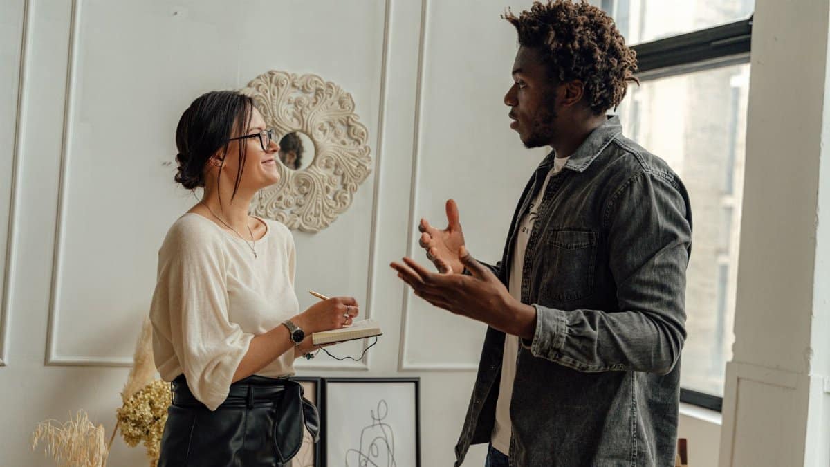 A man and woman engaging in a professional consultation in a stylish office setting, highlighting collaboration.