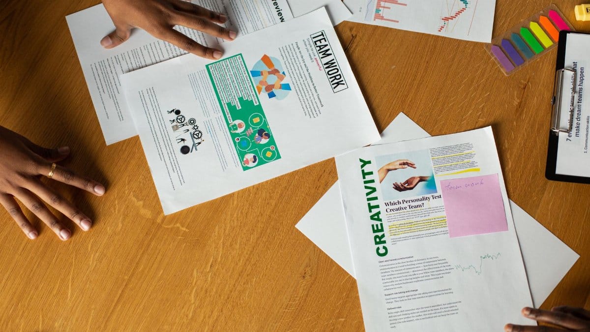Team members engage in a collaborative document review session, showcasing teamwork and creativity.