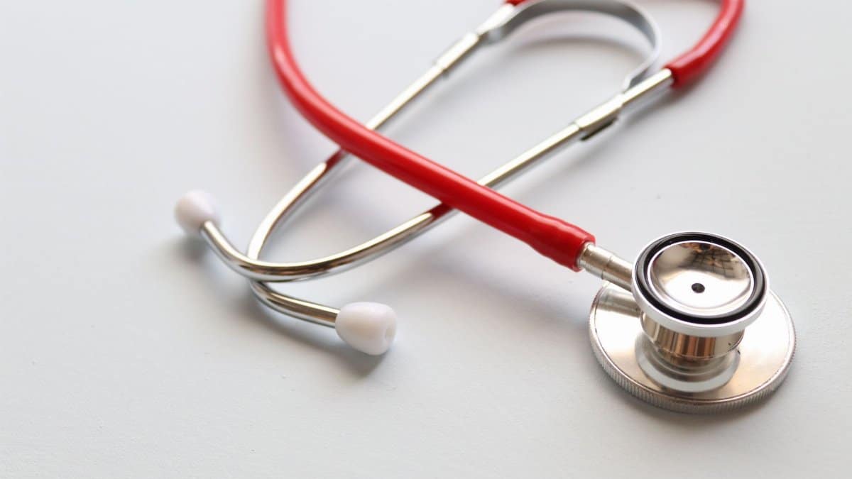 Close-up of a red stethoscope symbolizing medical care and healthcare diagnostics.
