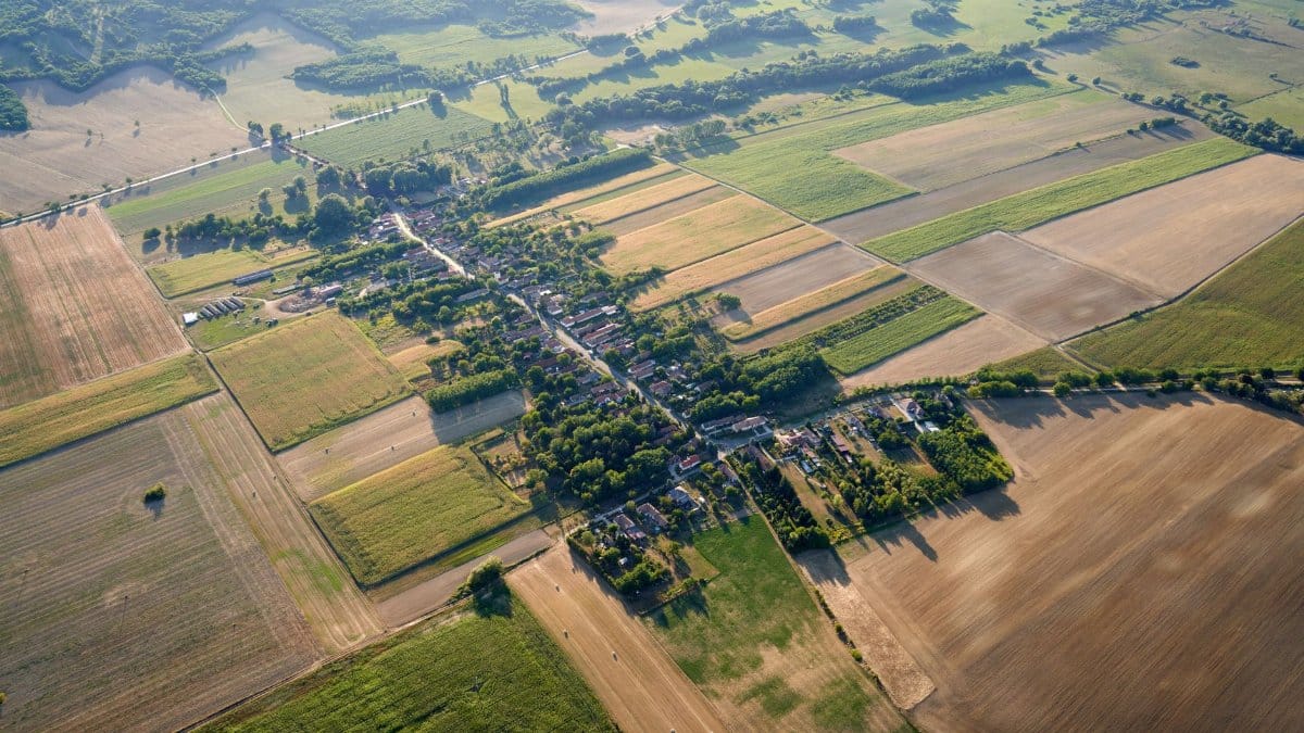 Stunning aerial view of Zalaszentlászló countryside showcasing fields and village layout.
