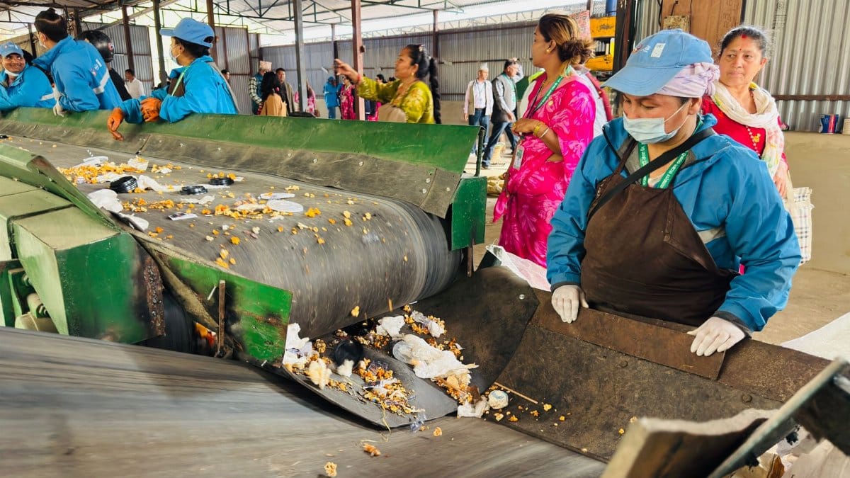 Workers sorting waste at a recycling plant in Butwal, Nepal, highlighting community recycling efforts.