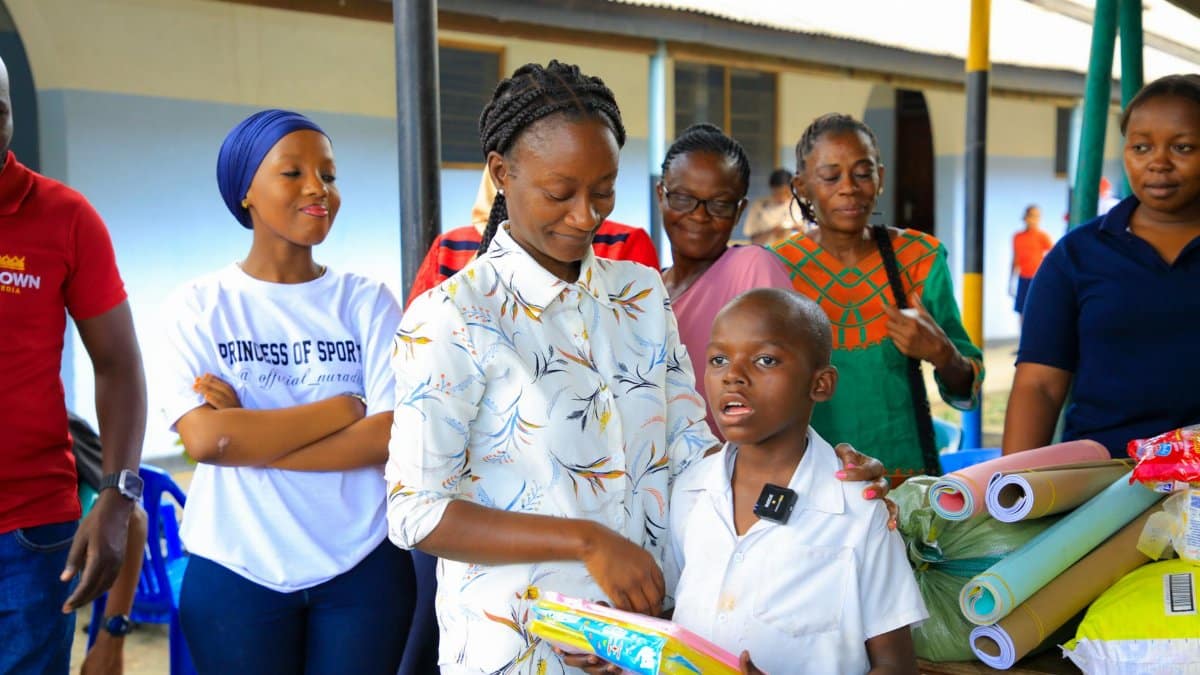A diverse group of adults and children enjoying a community education event indoors.