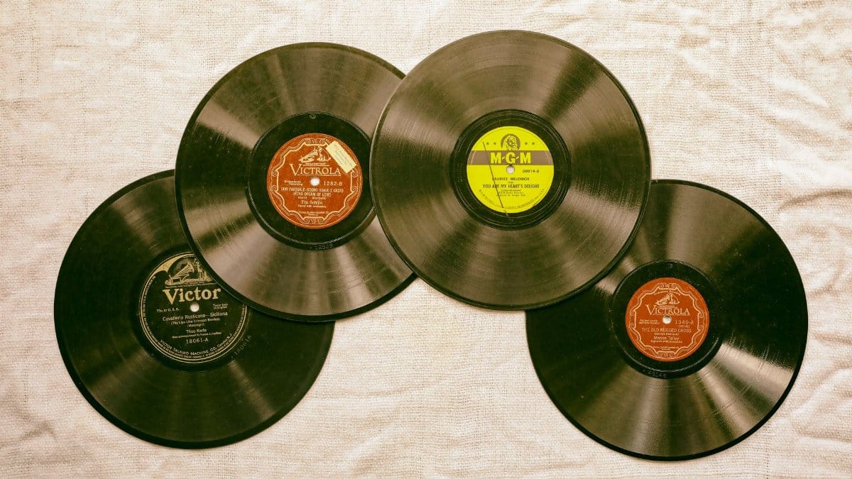 A collection of classic vintage vinyl records displayed on a textured background, evoking nostalgia and musical history.