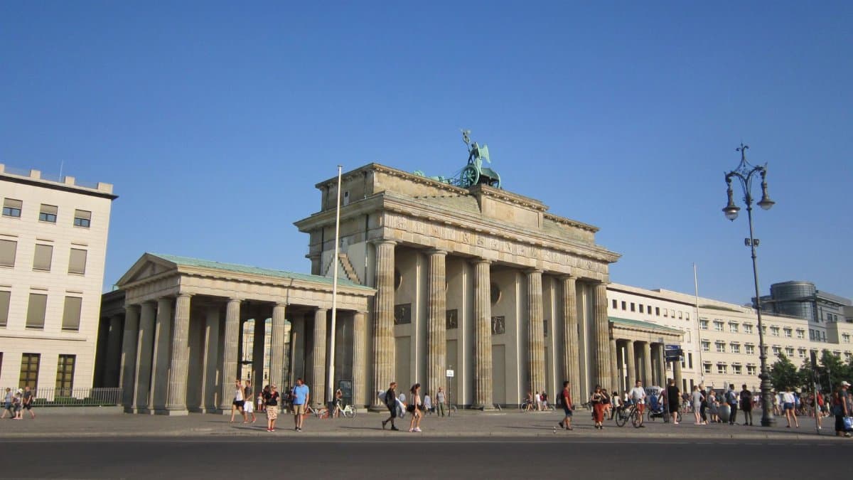 Explore the iconic Brandenburg Gate during a sunny day in Berlin, perfect for travel and tourism imagery.