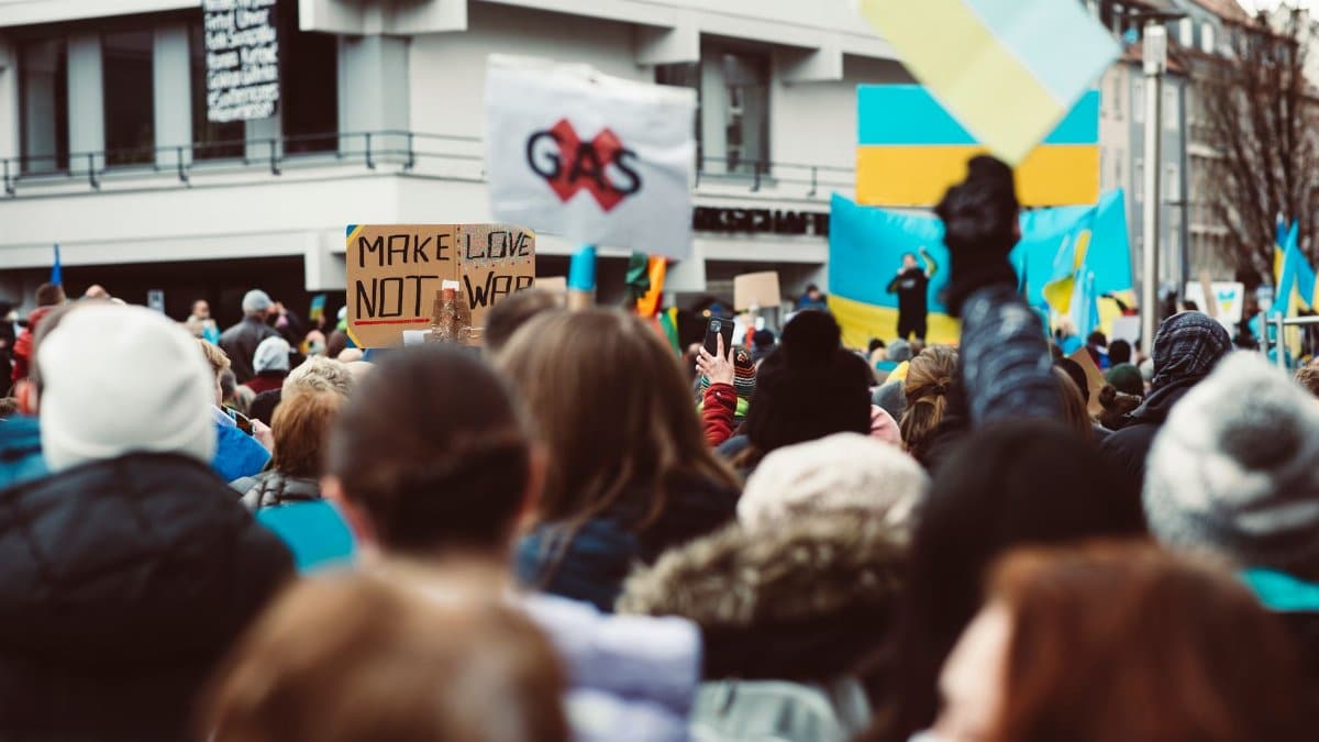 A vibrant protest with Ukraine flags, focusing on peace advocacy in an urban setting.