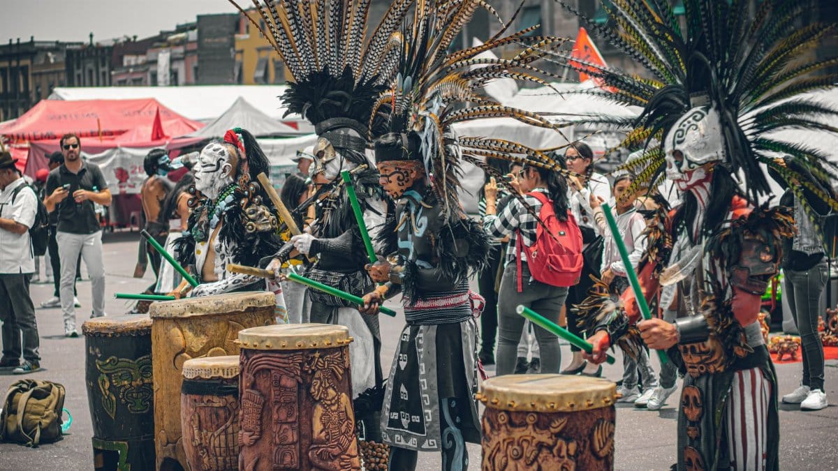 Traditional dancers in elaborate costumes perform in Mexico City, showcasing vibrant cultural heritage.