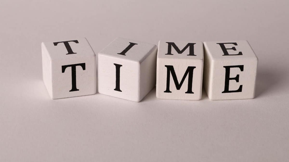 Wooden blocks with the word TIME on a white background, symbolizing concepts of time and creativity.