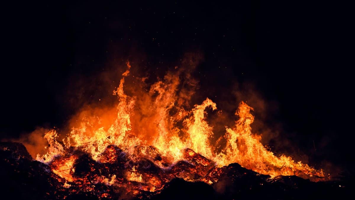 A fierce fire burning intensely at night in Torino, Italy, creating a dramatic scene.