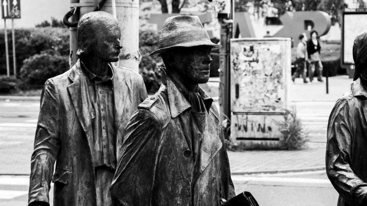Artistic black and white photo of street sculptures in an urban environment.
