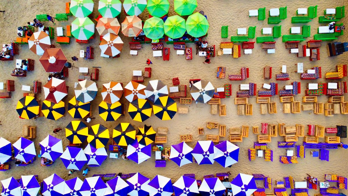 Vibrant aerial view of beach umbrellas and seating in Accra, Ghana.